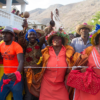 Celebrants hold maracas