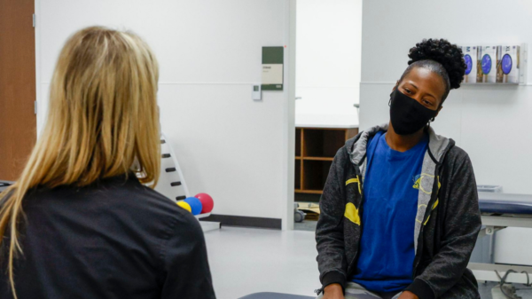 Chantel Thomas (right) works with senior physical therapist Katherine Resop