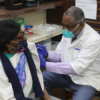 Pharmacist Serge Dorime delivers a coronavirus vaccine