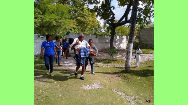 Employees of the nonprofit Capracare transport a person injured in a Dec. 21 earthquake that struck southwestern Haiti.