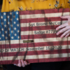 Katie McCoy holds a wooden American flag