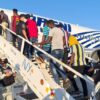 Haitians board a plane