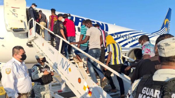 Haitians board a plane