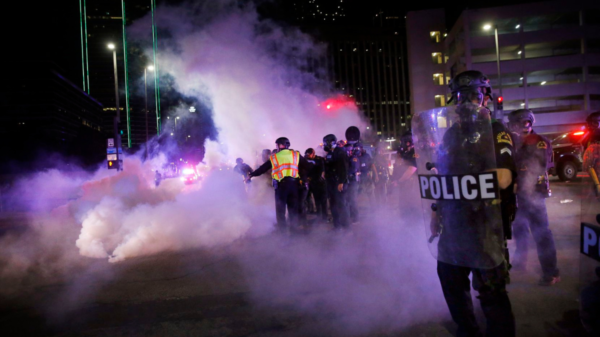 Dallas Police tactical officers fire rounds of tear gas at protestors