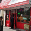 A man waits in the doorway of a Church Avenue money transfer store