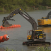 Workers deploy large buoys