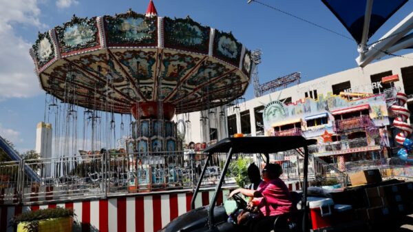 Workers ride a cart