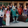 Journalism students with UNT mascot