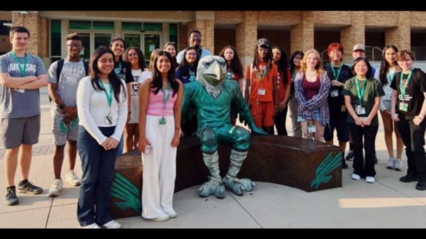 Journalism students with UNT mascot