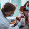 mother taking her daughter to the pediatrician to get vaccinated