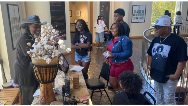 Glover with cotton exhibit at African American Museum during Grambling-Prairie View game