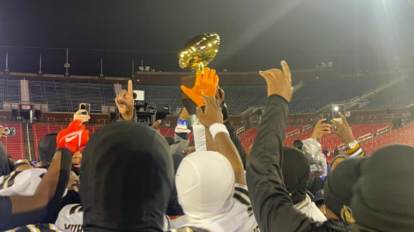 The South Oak Cliff Bears raise their trophy high after claiming a spot in their fourth consecutive state championship